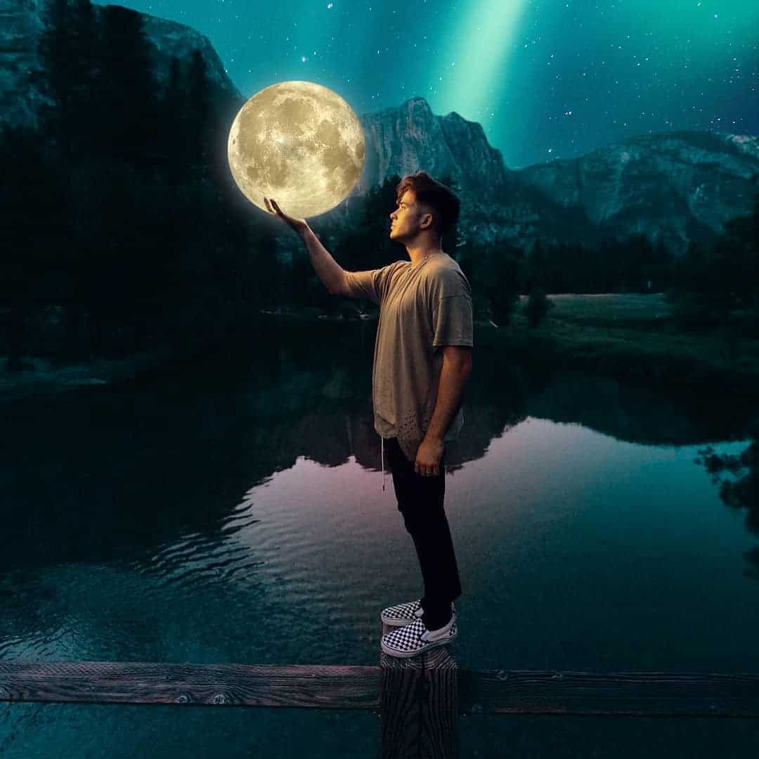 guy holding a moon in his hand