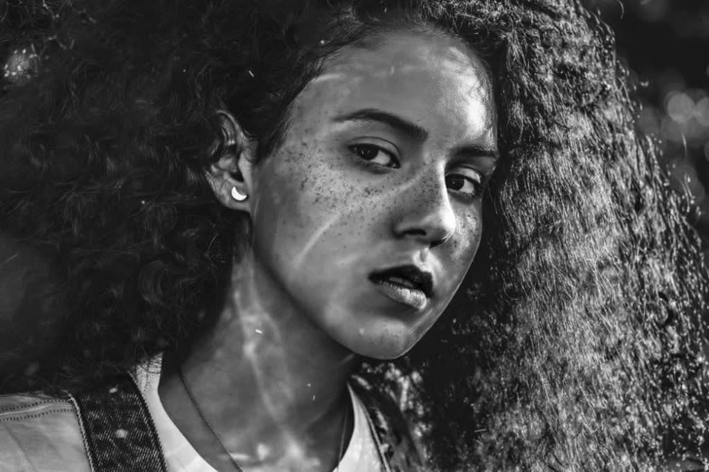 black and white portrait of young girl with freckles